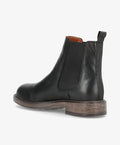 Sort læder Chelsea-støvle fra Shoedesign Copenhagen med elastiske sidepaneler og brun sål.